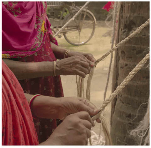 Artisans braiding natural fibres by hand
